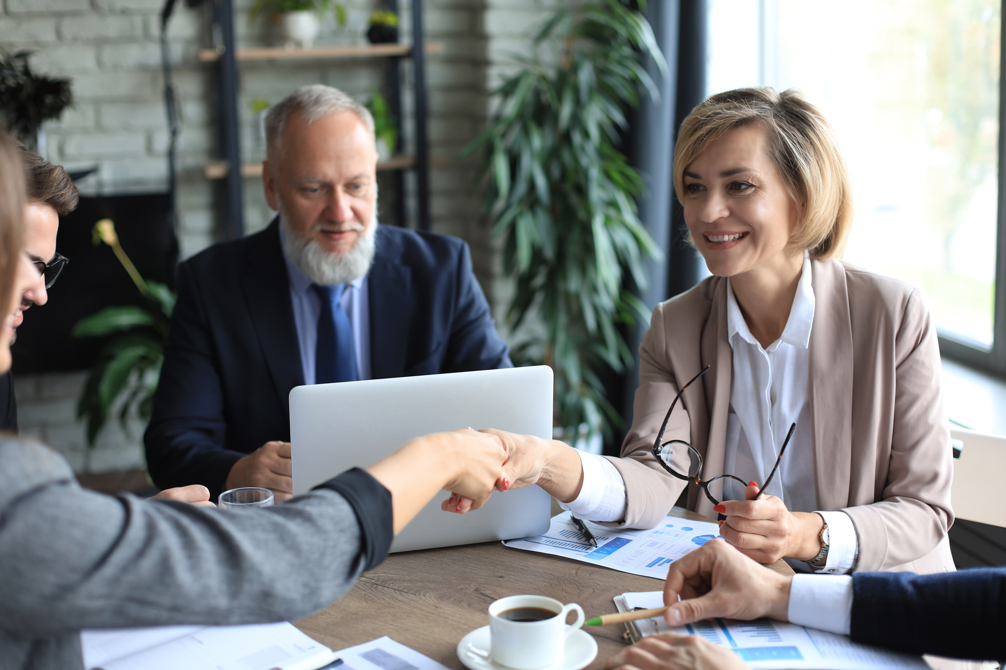 Business people shaking hands, finishing up a meeting.