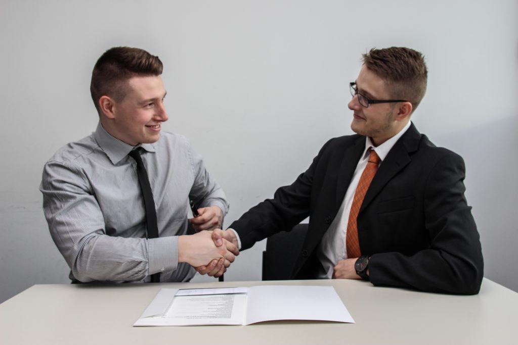 two businessmen shaking hands in agreement