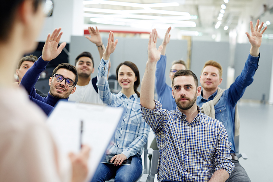 Business people raising their hands to ask questions about selling a business