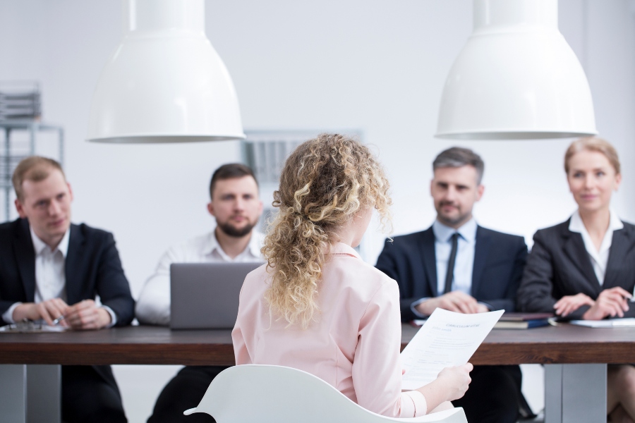 Innovative candidate sitting in front of management board during interview