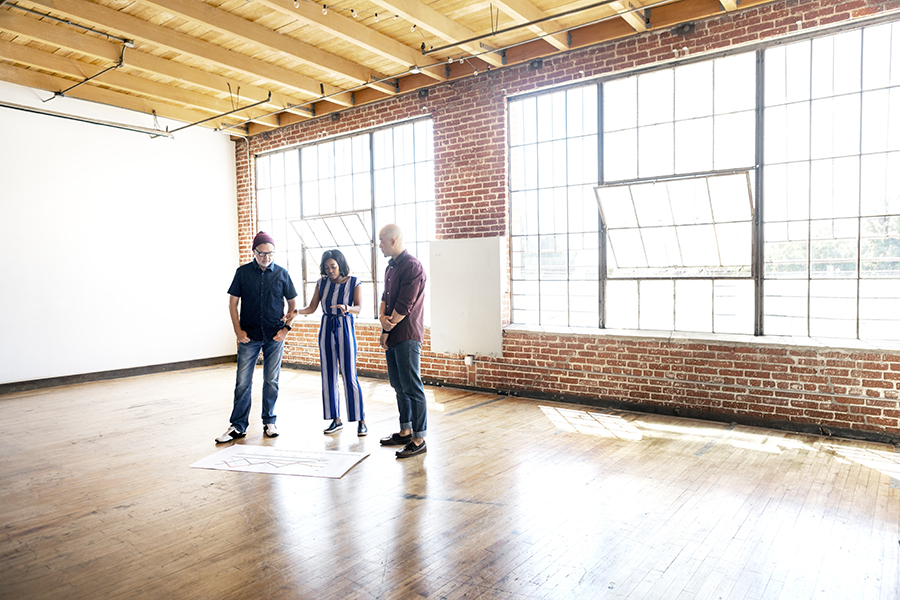 Three people in empty space looking to grow your business